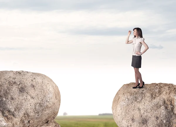 Businesswoman on rock mountain — Stock Photo, Image