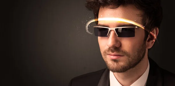 Handsome man looking with futuristic high tech glasses