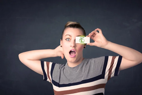 Jovem segurando papel com sinal de dólar verde — Fotografia de Stock