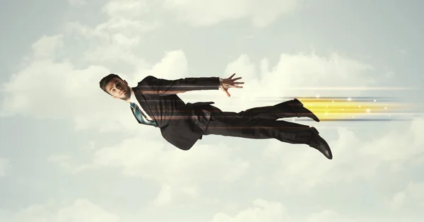 Happy business man flying fast on the sky between clouds — Stock Photo, Image