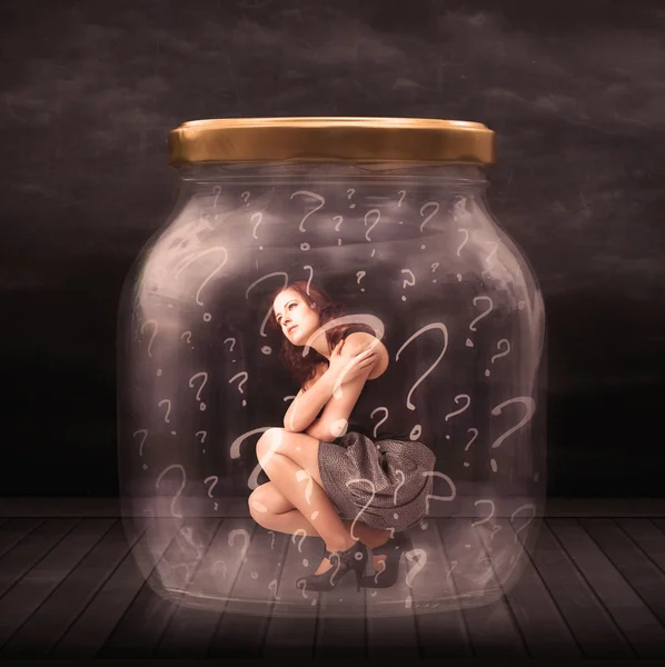 Businesswoman locked into a jar with question marks concept — Stock Photo, Image