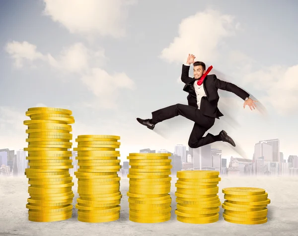 Successful business man jumping up on gold coin money — Stock Photo, Image