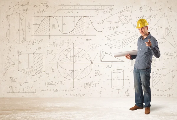 Handsome engineer calculating with hand drawn background — Stock Photo, Image