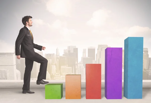 Business person climbing up on colourful chart pillars concept — Stock Photo, Image