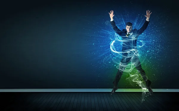 Talented cheerful businessman jumping with glowing energy lines — Stock Photo, Image