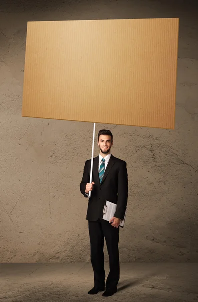 Businessman with blank cardboard — Stock Photo, Image