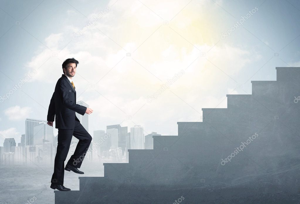 Businessman climbing up a concrete staircase concept