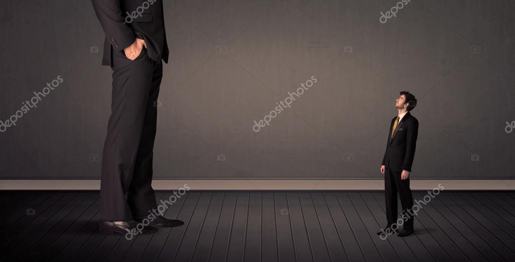Little bussinesman in front of a giant boss legs concept — Stock