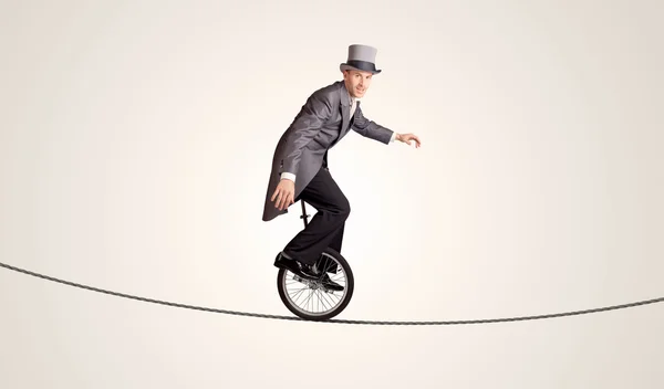 Extreme business man riding unicycle on a rope — Stock Photo, Image