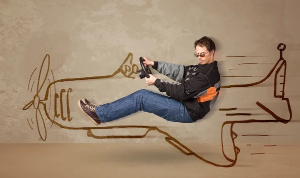 Vtipný pilot řídí ručně kreslené letadlo na stěně — Stock fotografie