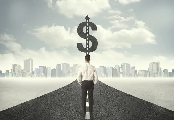 Business man on road heading toward a dollar sign — Stock Photo, Image