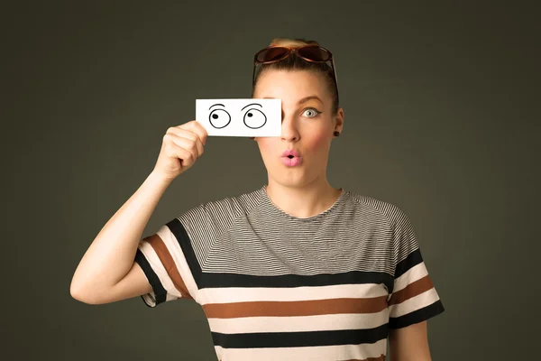 Young silly girl looking with hand drawn eye balls on paper — Stock Photo, Image