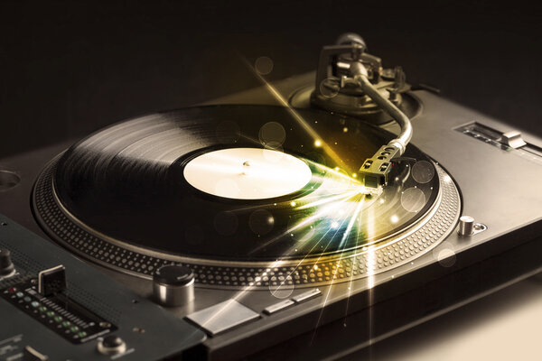 Music player playing vinyl with glow lines coming from the need
