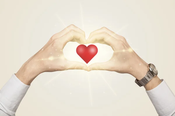 Hands creating a form with shining heart — Stock Photo, Image