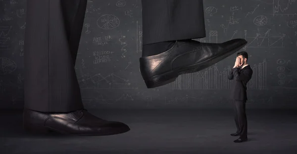 Huge leg stepping on a tiny businnessman concept — Stock Photo, Image