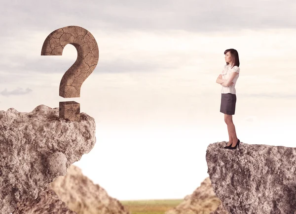 Businesswoman on rock mountain with a question mark — Stock Photo, Image