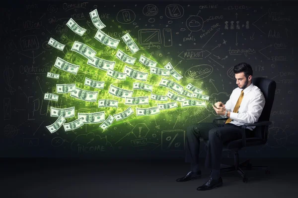 Businessman sitting in chair holding tablet with dollar bills co — Stock Photo, Image