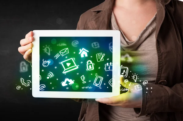 Person holding tablet with green media icons and symbols — Stock Photo, Image