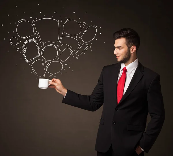 Businessman holding a white cup with speech bubbles — Stock Photo, Image