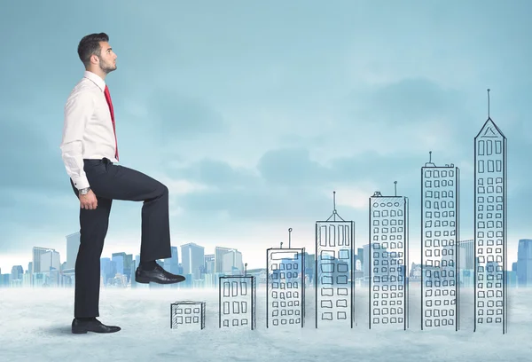 Business man climbing up on hand drawn buildings in city — Stock Photo, Image