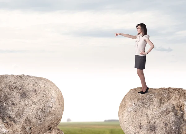 Businesswoman on rock mountain — Stock Photo, Image