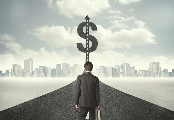 Business man on road heading toward a dollar sign — Stock Photo, Image