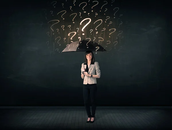 Businesswoman with umbrella and a lot of drawn question marks — Stock Photo, Image