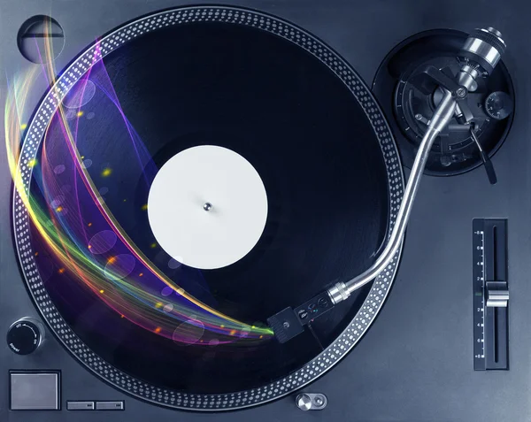 Turntable playing vinyl with glowing abstract lines — Stock Photo, Image