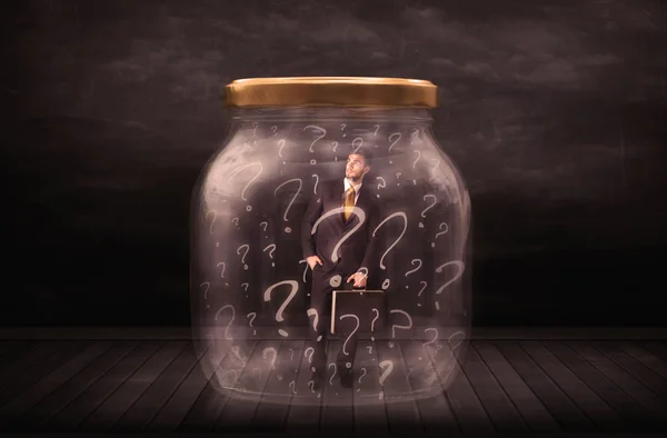 Businessman locked into a jar with question marks concept — Stock Photo, Image