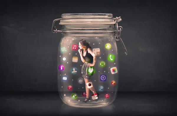 Businesswoman captured in a glass jar with colourful app icons c — Stock Photo, Image