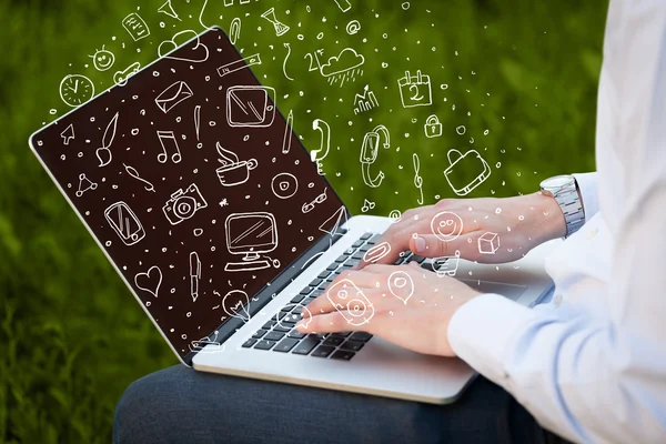 Laptop computer wtih hand drawn icons and symbols — Stock Photo, Image