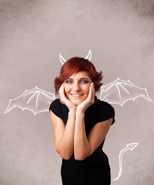 Young girl with devil horns and wings drawing — Stock Photo, Image