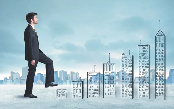 Business man climbing up on hand drawn buildings in city — Stock Photo, Image