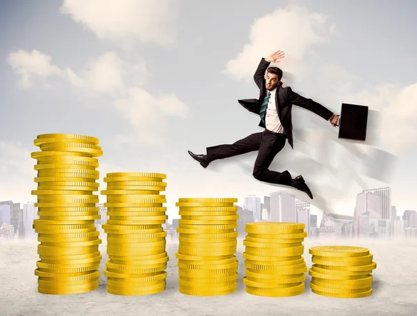 Successful business man jumping up on gold coin money — Stock Photo, Image