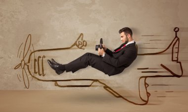 Duvara el çizimi uçak süren komik pilot.