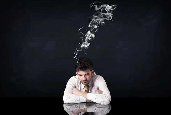 Depressed businessman with smoking head — Stock Photo, Image