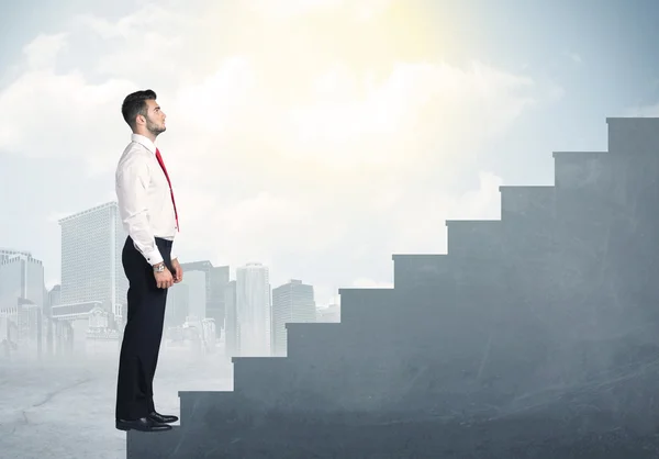 Businessman climbing up a concrete staircase concept — Stock Photo, Image