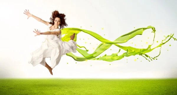 Pretty girl jumping with green abstract liquid dress — Stock Photo, Image