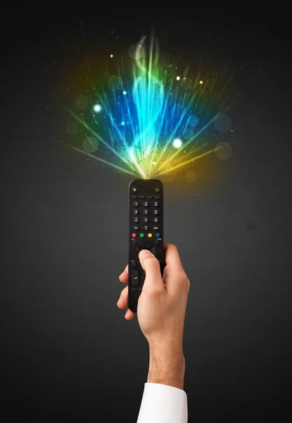 Hand with remote control and explosive signal — Stock Photo, Image