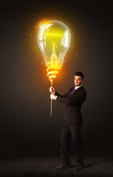 Businessman with an idea bulb — Stock Photo, Image