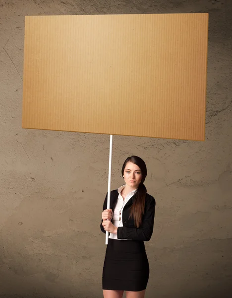 Businesswoman with blank cardboard — Stock Photo, Image