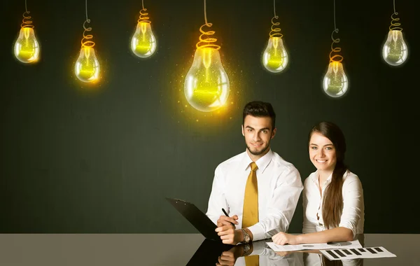Business couple with idea bulbs — Stock Photo, Image