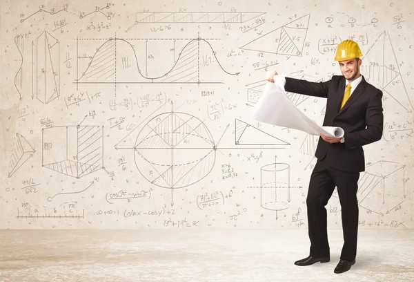 Ingeniero guapo calculando con fondo dibujado a mano —  Fotos de Stock