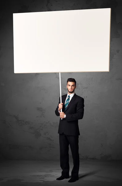 Businessman with blank whiteboard — Stock Photo, Image