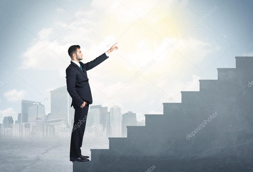 Businessman climbing up a concrete staircase concept