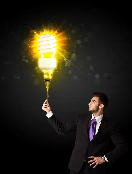 Businessman with an eco-friendly bulb — Stock Photo, Image