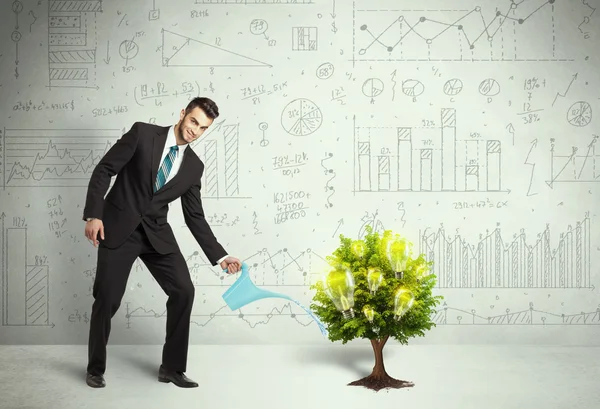 Business man pouring water on lightbulb growing tree — Stock Photo, Image