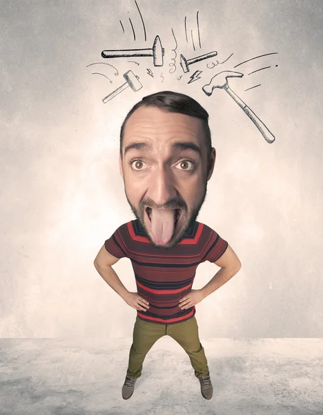 Big head person with drawn hammers — Stock Photo, Image