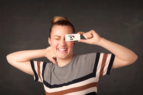 Silly youngster looking with hand drawn eye paper — Stock Photo, Image