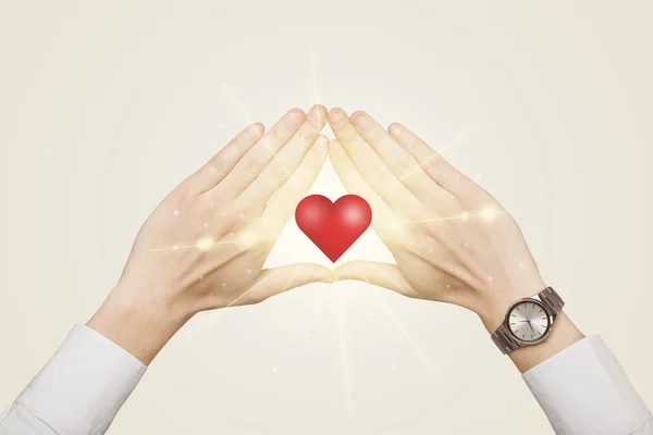 Hands creating a form with shining heart — Stock Photo, Image